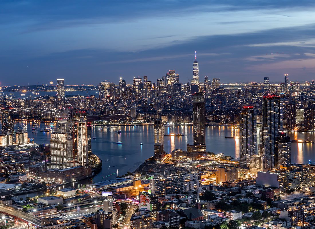 Contact - An Aerial View of the Downtown New York City Skyline From Long Island City at Dusk